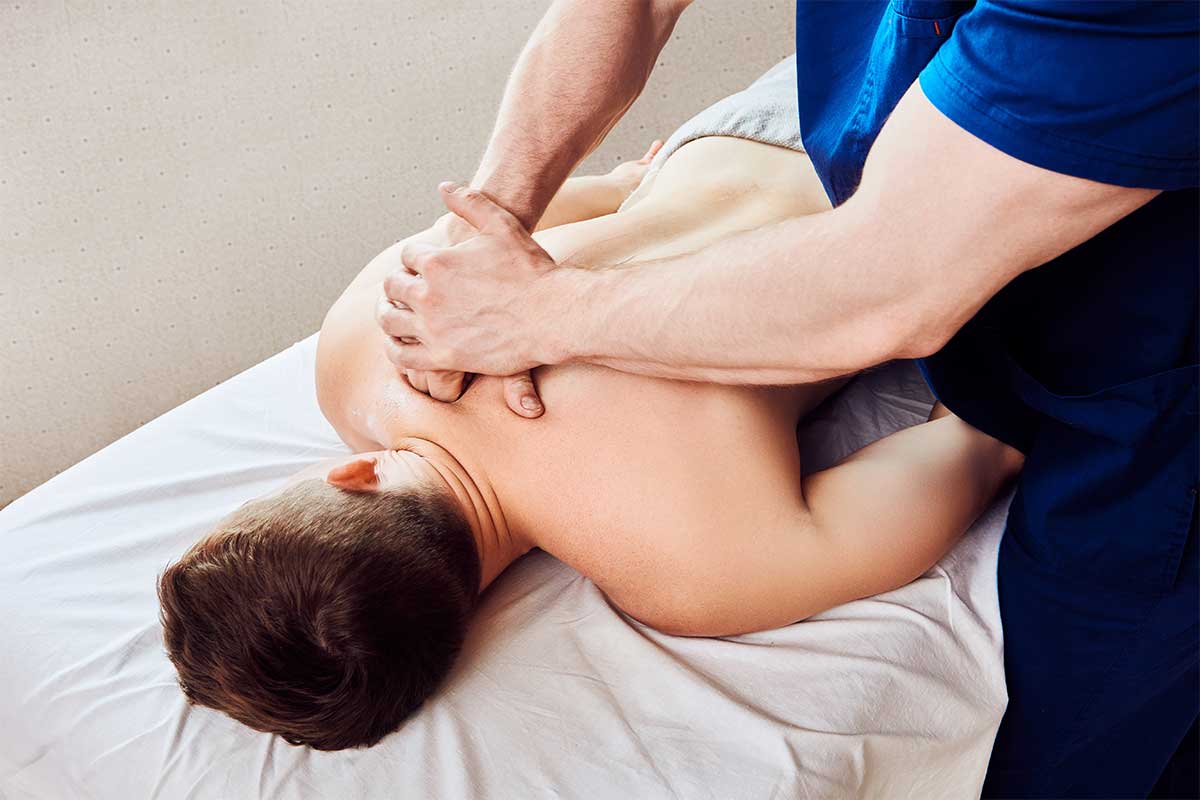 Soft tissue therapist in Bristol releasing tension in a client's neck and shoulder
